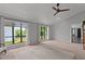 Bright living room featuring large windows, a ceiling fan, and neutral tones throughout the room at 7309 Forest Glade Ct, Raleigh, NC 27615