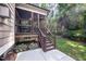 Charming back porch with stairs leading to a concrete patio and lush backyard at 7809 Chestnut Branch Ct, Raleigh, NC 27612