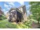 Beautiful backyard featuring a screened-in porch, lush lawn, and mature trees at 7809 Chestnut Branch Ct, Raleigh, NC 27612