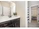 Bathroom featuring a dark wood vanity with a white marble countertop and a shower with a striped curtain at 7809 Chestnut Branch Ct, Raleigh, NC 27612
