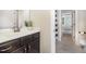 Bathroom featuring a dark wood vanity with a white marble countertop and a shower with a striped curtain at 7809 Chestnut Branch Ct, Raleigh, NC 27612