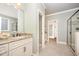 Well lit bathroom showcases a granite vanity, tiled floor and a large enclosed shower at 7809 Chestnut Branch Ct, Raleigh, NC 27612