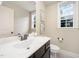 Bright bathroom features a white marble vanity, sink, and classic fixtures at 7809 Chestnut Branch Ct, Raleigh, NC 27612