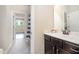 Bathroom with a dark wood vanity, marble countertop, and a striped shower curtain at 7809 Chestnut Branch Ct, Raleigh, NC 27612
