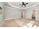 Spacious bedroom features trey ceilings, a ceiling fan, and a view to an open ensuite at 7809 Chestnut Branch Ct, Raleigh, NC 27612