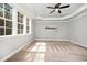 Bright bedroom featuring trey ceilings, a ceiling fan, and large windows at 7809 Chestnut Branch Ct, Raleigh, NC 27612