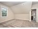 Bedroom featuring an angled ceiling, carpeted floors, and a window at 7809 Chestnut Branch Ct, Raleigh, NC 27612