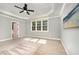 Relaxing bedroom with trey ceilings, ceiling fan, and a view to an open ensuite at 7809 Chestnut Branch Ct, Raleigh, NC 27612