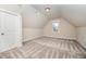 Bedroom featuring an angled ceiling, carpeted floors, and a window at 7809 Chestnut Branch Ct, Raleigh, NC 27612