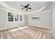 Inviting bedroom with coffered ceilings, a ceiling fan, and large windows at 7809 Chestnut Branch Ct, Raleigh, NC 27612