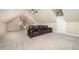 Spacious bonus room features plush carpeting, ceiling fan, and a comfortable media sofa at 7809 Chestnut Branch Ct, Raleigh, NC 27612