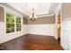 Elegant dining room with wainscoting, hardwood floors, and natural light at 7809 Chestnut Branch Ct, Raleigh, NC 27612