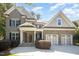 Charming two-story brick home with a welcoming front porch and a two-car garage at 7809 Chestnut Branch Ct, Raleigh, NC 27612