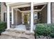 Inviting front porch with stone steps, columns, and space for seating and decor at 7809 Chestnut Branch Ct, Raleigh, NC 27612
