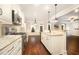 Open kitchen featuring granite countertops, stainless steel appliances, and hardwood floors at 7809 Chestnut Branch Ct, Raleigh, NC 27612