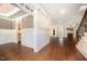 Open-concept living space featuring dark hardwood floors and decorative wainscoting at 7809 Chestnut Branch Ct, Raleigh, NC 27612