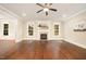Elegant living room boasts dark hardwood floors, a fireplace, and natural light at 7809 Chestnut Branch Ct, Raleigh, NC 27612