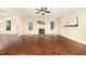 Spacious living room featuring dark hardwood floors, a fireplace, and lots of natural light at 7809 Chestnut Branch Ct, Raleigh, NC 27612