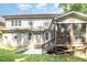 Back exterior of the home with screened in porch and concrete patio at 7809 Chestnut Branch Ct, Raleigh, NC 27612