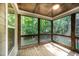 Inviting screened-in porch boasts natural wood accents and serene wooded views at 7809 Chestnut Branch Ct, Raleigh, NC 27612