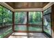 Relaxing screened porch features wood flooring, ceiling, and beautiful wooded view at 7809 Chestnut Branch Ct, Raleigh, NC 27612