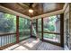 Beautiful screened porch with wood ceiling and flooring offers serene wooded views at 7809 Chestnut Branch Ct, Raleigh, NC 27612