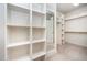 Organized walk-in closet featuring built-in shelving and ample storage space at 7809 Chestnut Branch Ct, Raleigh, NC 27612