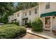 Stylish townhouses showcasing attractive landscaping and neat exteriors, framed by lush greenery at 8 Mandy Ct, Durham, NC 27707