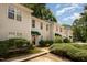 Charming townhouse complex with inviting green awning at the doorway and well-maintained landscaping at 8 Mandy Ct, Durham, NC 27707