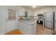 Functional kitchen with stainless steel appliances, white cabinets, and ample countertop space at 8 Mandy Ct, Durham, NC 27707