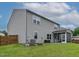 Rear view of home featuring a screened-in porch and an expansive backyard at 8005 Caithness St, Raleigh, NC 27616
