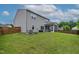 Back exterior view showing a spacious yard, screened in porch, and vinyl siding at 8005 Caithness St, Raleigh, NC 27616