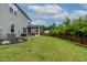 Large, fenced backyard with lush lawn, landscaping and screened-in porch offers great outdoor living at 8005 Caithness St, Raleigh, NC 27616