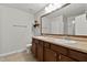 Bathroom featuring double vanity, framed mirror, wood cabinets and a separate glass door shower at 8005 Caithness St, Raleigh, NC 27616