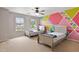 Spacious bedroom with colorful accent wall, carpeted floor, and two twin beds at 8005 Caithness St, Raleigh, NC 27616