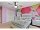 Bedroom with a pink and green accent wall, carpeted floor, and closet at 8005 Caithness St, Raleigh, NC 27616