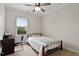 Bright bedroom features a window with blinds, a ceiling fan, and a comfortable bed for a peaceful rest at 8005 Caithness St, Raleigh, NC 27616