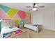 Bright bedroom with colorful accent wall, carpeted floor, and two twin beds at 8005 Caithness St, Raleigh, NC 27616