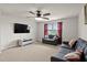 Large bonus room features a ceiling fan, big tv and lots of natural light, perfect for entertaining at 8005 Caithness St, Raleigh, NC 27616
