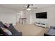 Second floor bonus room features a ceiling fan, tv and lots of natural light, perfect for relaxing at 8005 Caithness St, Raleigh, NC 27616