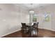 Bright dining area with modern chandelier, table for four, and convenient access to the outdoors at 8005 Caithness St, Raleigh, NC 27616