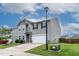 Two-story home featuring a two-car garage, well-kept lawn, and blue skies above at 8005 Caithness St, Raleigh, NC 27616