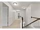 Bright hallway features neutral walls and carpet leading to bedrooms and bathrooms at 8005 Caithness St, Raleigh, NC 27616