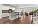 Kitchen and living room include stainless appliances, granite countertops, and breakfast bar at 8005 Caithness St, Raleigh, NC 27616