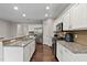Spacious kitchen with granite countertops, stainless appliances, and hardwood floors at 8005 Caithness St, Raleigh, NC 27616