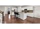 Open kitchen with breakfast bar, stainless appliances, granite countertops, and hardwood floors at 8005 Caithness St, Raleigh, NC 27616