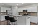 Bright kitchen features white cabinets, granite countertops, stainless appliances, and breakfast bar at 8005 Caithness St, Raleigh, NC 27616