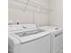 Laundry room features a washing machine, dryer, and overhead wire shelf at 8005 Caithness St, Raleigh, NC 27616