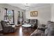 Comfortable living room boasts hardwood floors, modern lighting, and gray upholstered furniture at 8005 Caithness St, Raleigh, NC 27616