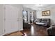 Cozy living room features hardwood floors, updated lighting fixture, and comfortable seating at 8005 Caithness St, Raleigh, NC 27616
